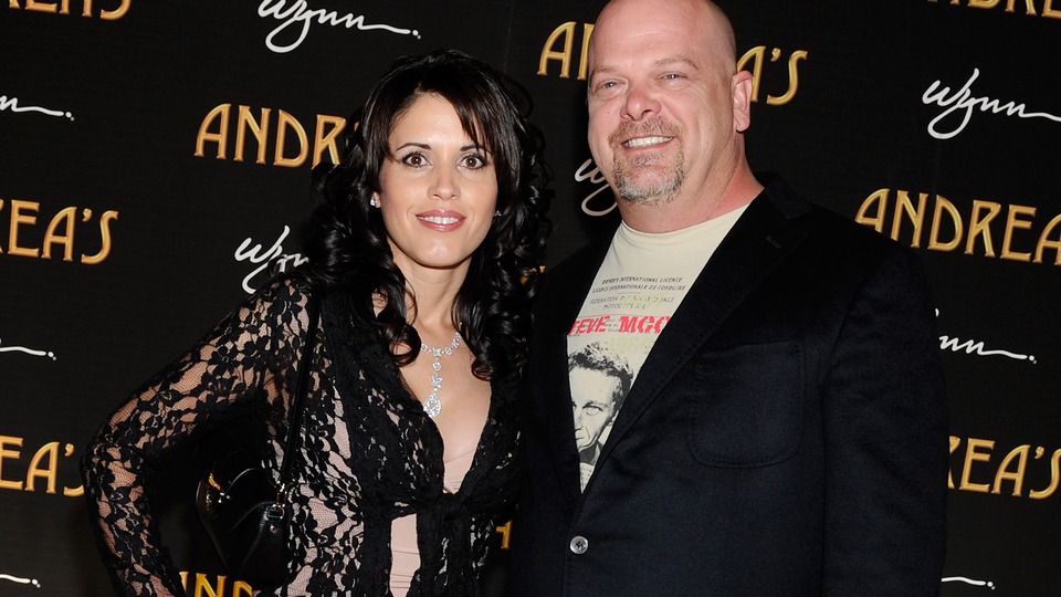 Deanna Burditt and Rick Harrison smiling together on the red carpet at an evening charity benefit in Las Vegas.