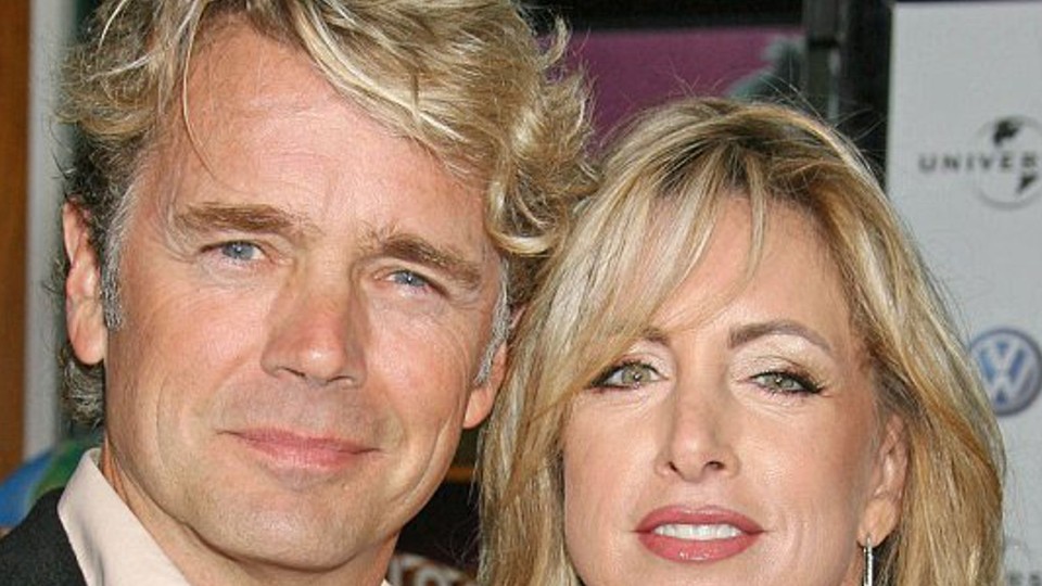 John Schneider and wife Elly Castle arriving at movie premiere